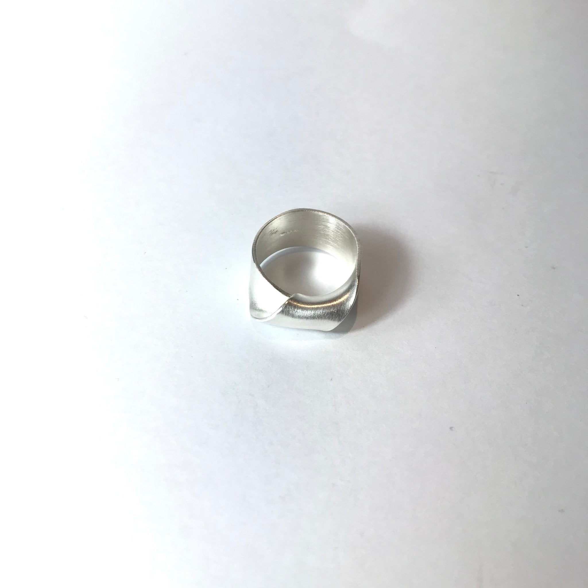 Sleek silver-toned ring with modern geometric angular facets