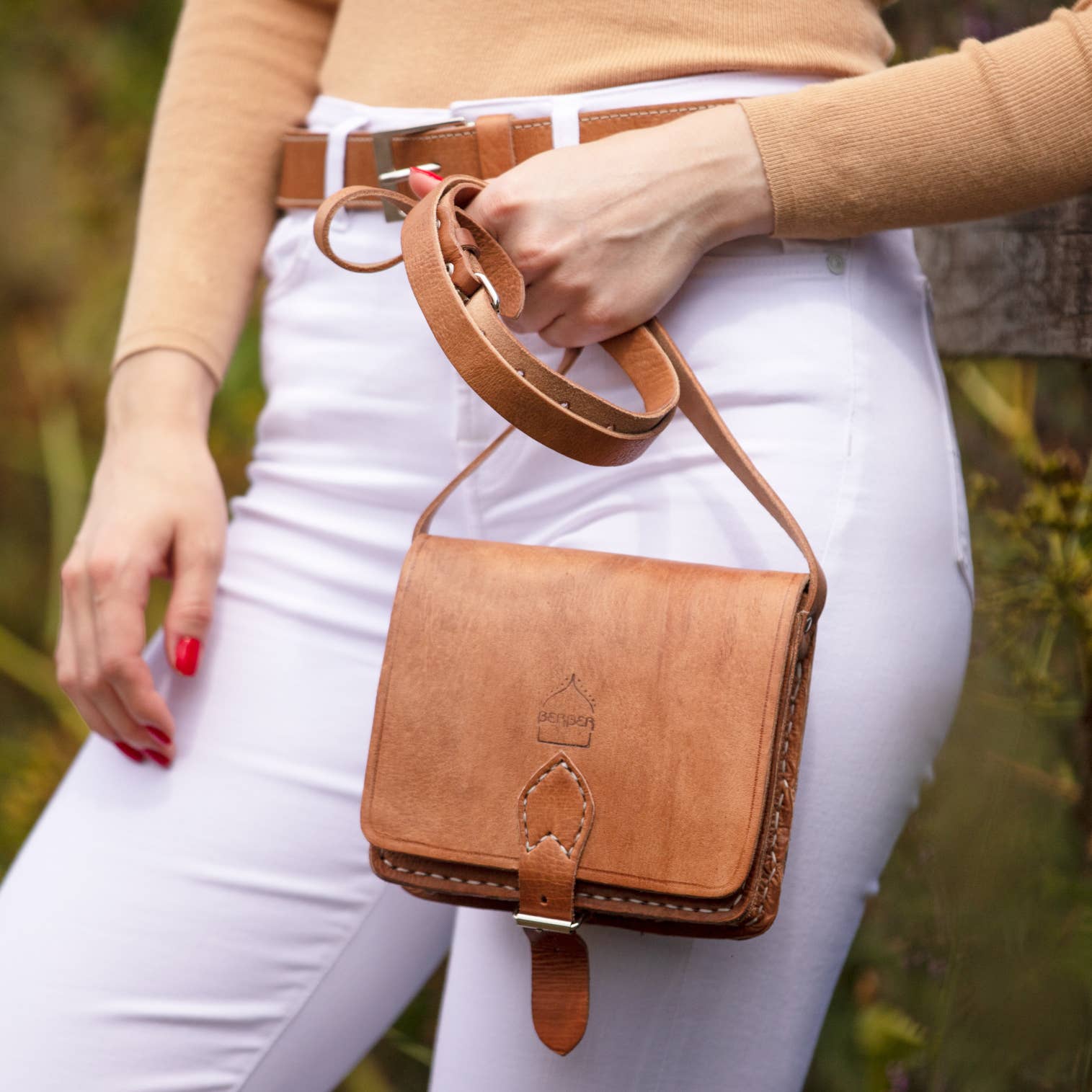 Dark brown small square leather saddle bag with tan crossbody strap