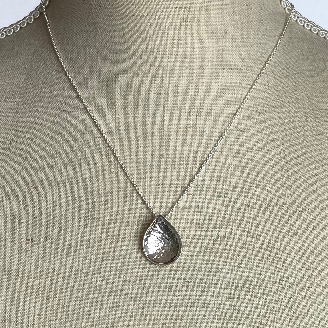 Silver teardrop pendant necklace with hammered texture and delicate chain